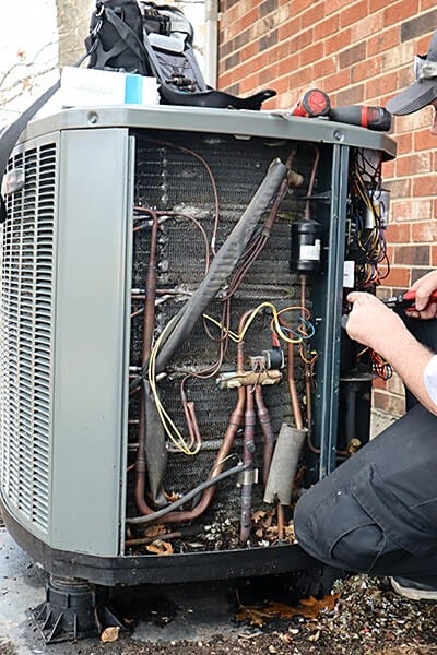 person working on air conditioner