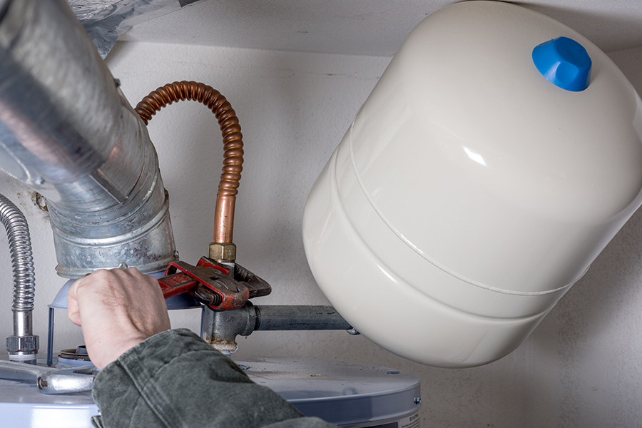 Plumber performing water heater repair