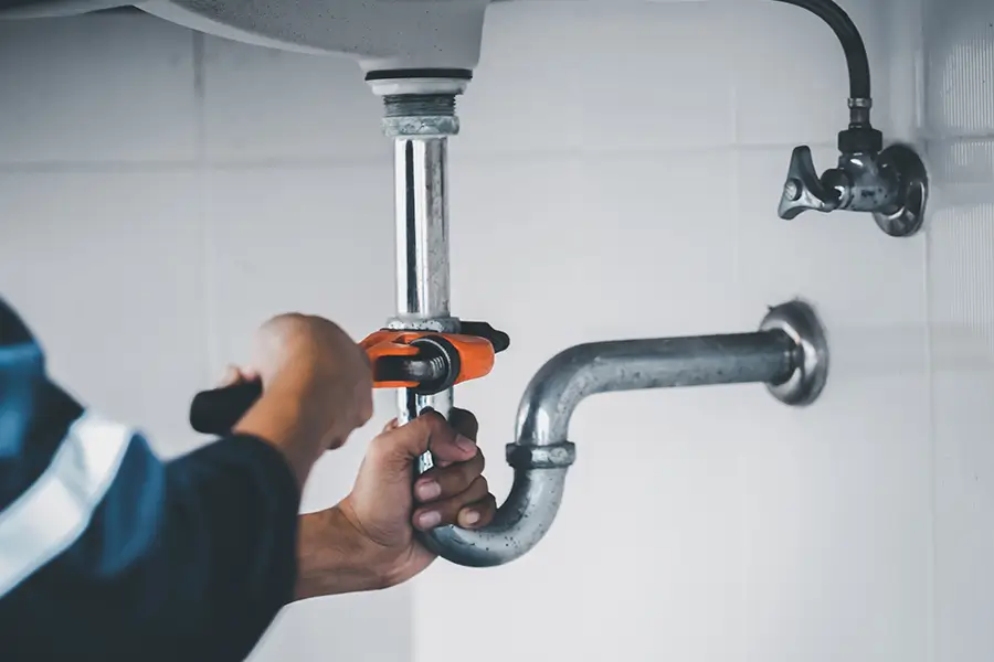 Plumber performing plumbing maintenance
