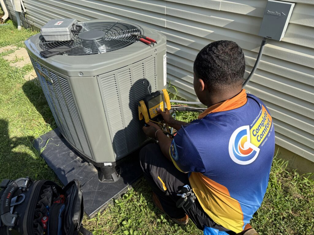 HVAC technician working on AC.